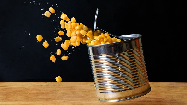 canned corn spilling from container