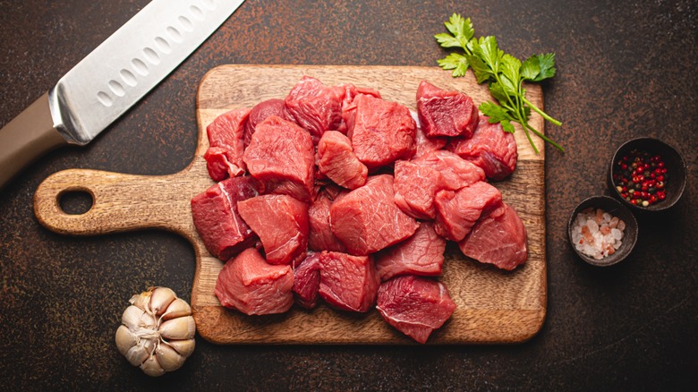 Stew meat on wood cutting board