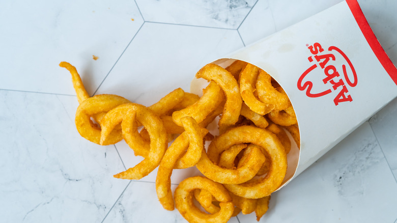 Arby's curly fries spilling out 