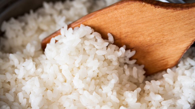 white rice with wooden spatula