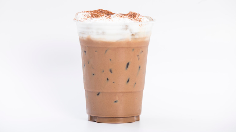 iced coffee in plastic cup topped with cold foam