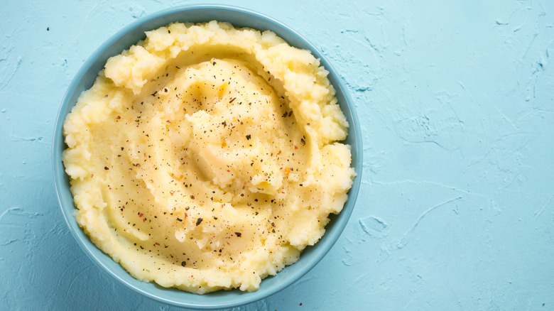Creamy mashed potatoes in a bowl with seasoning