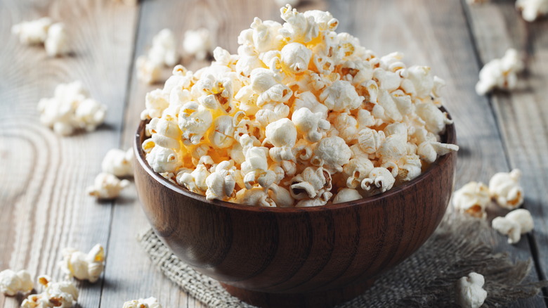 popcorn overflowing in wood bowl
