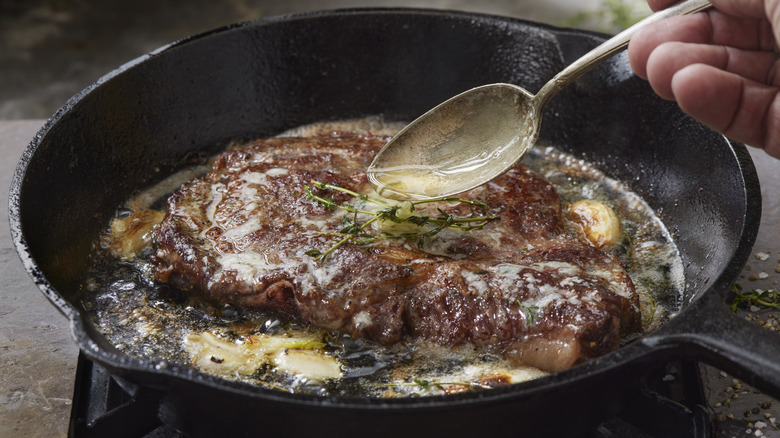 steak with butter in pan