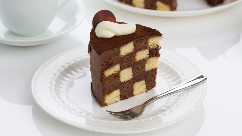 Slice of checkerboard cake and coffee