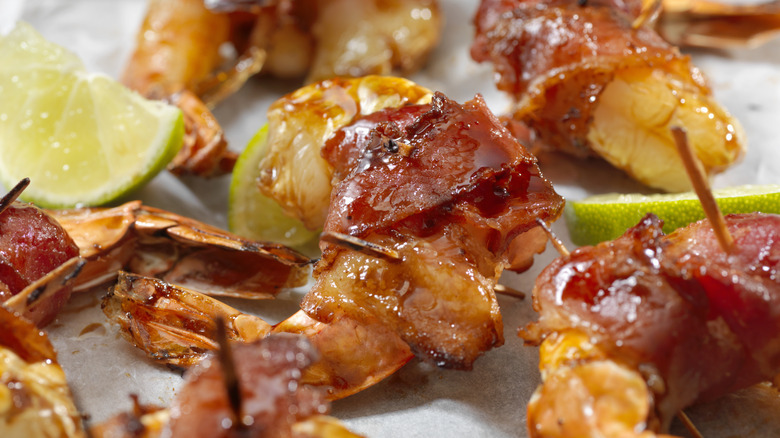 maple glazed bacon wrapped shrimp with lime wedges