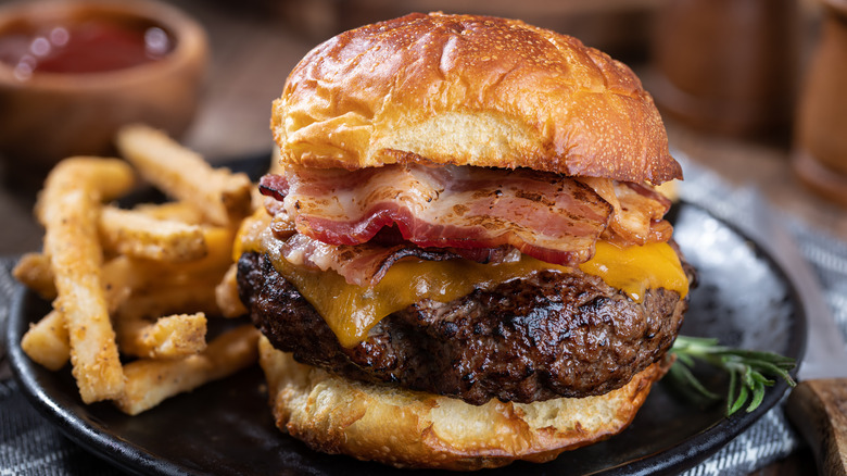 Burger topped with cheese and bacon
