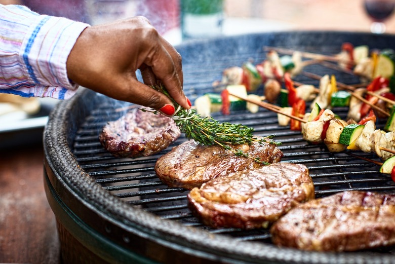 Today Meal's Ultimate Grilling Guide - black manicured hand grills steak and veggie kebabs