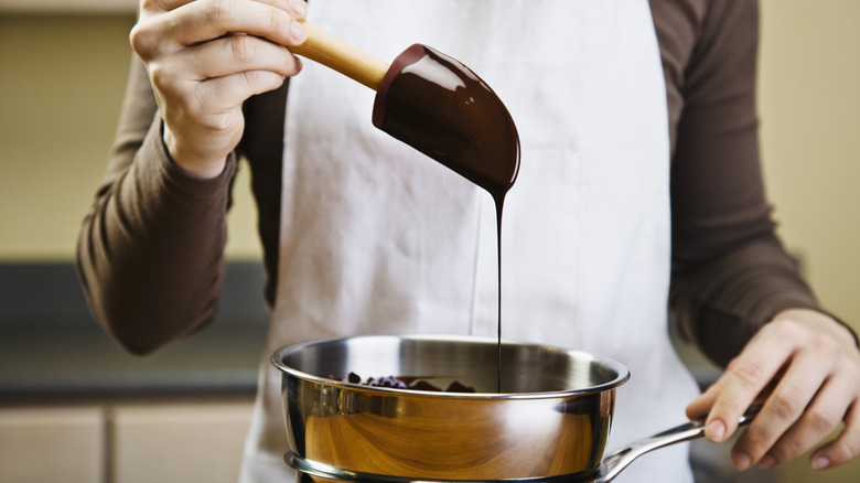 Melted chocolate dripping from spatula 