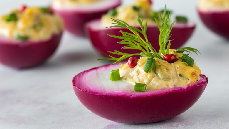 Deviled eggs dyed with pickled beets