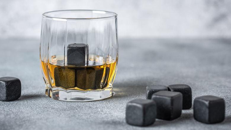 Whiskey in a glass with cube shaped stones