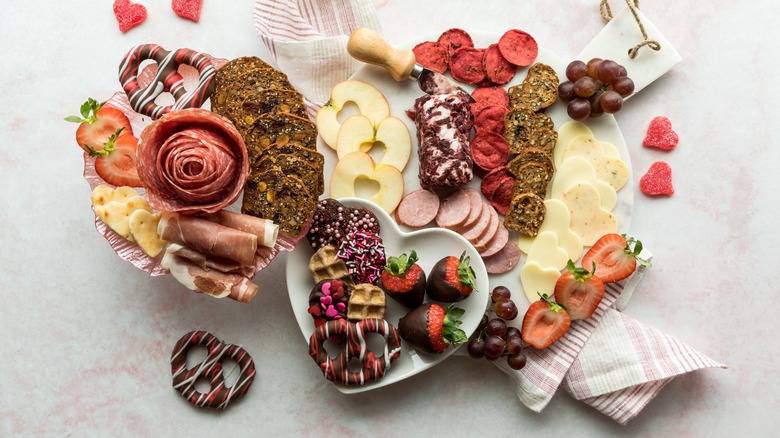 charcuterie board with chocolate, cheese, meat, fruits