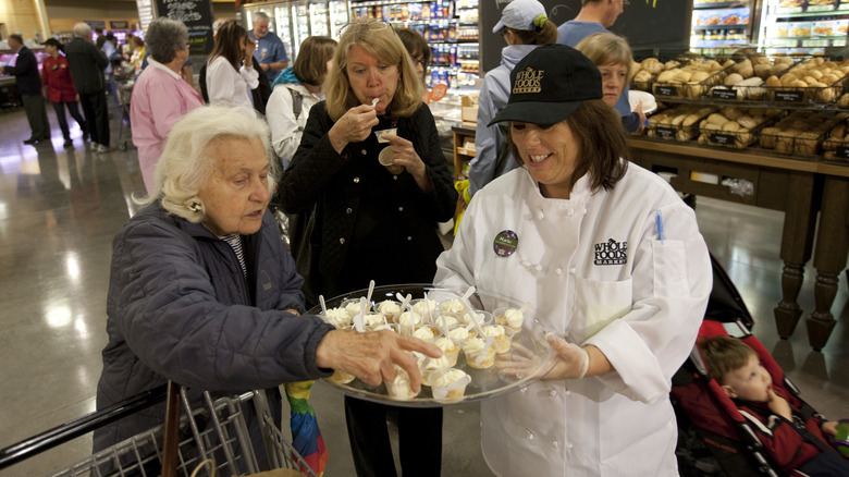 Whole Foods employee handing out samples to shoppers