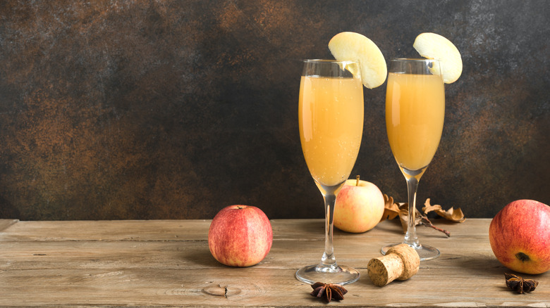 Apple cider Bellini in flute glasses with apple garnish