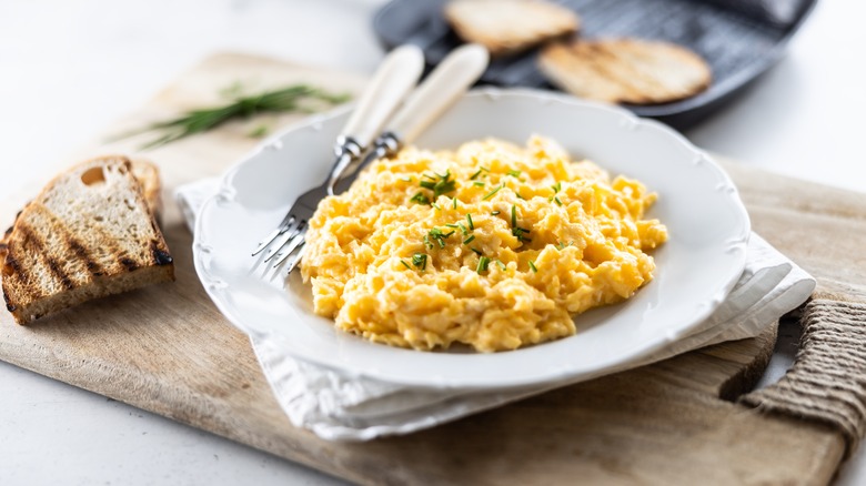Scrambled eggs with grilled bread on plate