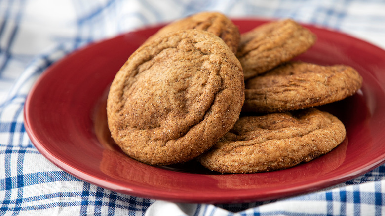 Snickerdoodles on red plate on plaid tablecloth