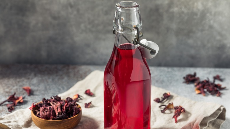 tea infused simple syrup with dried flowers in background