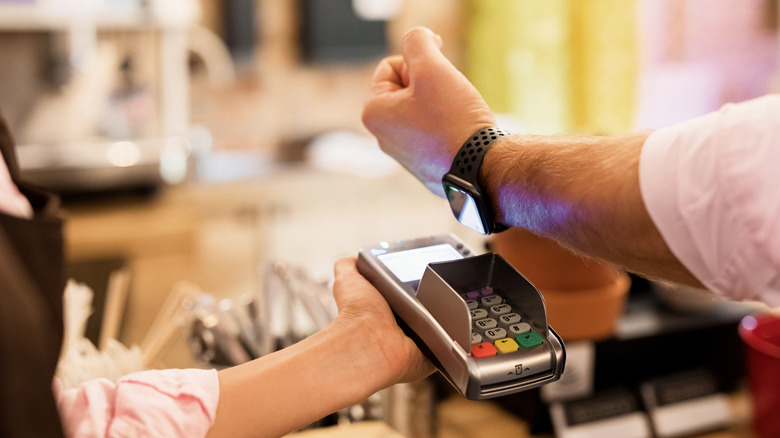 Person paying with smartwatch 