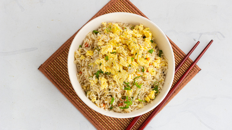 fried rice with egg on placemat with chopsticks