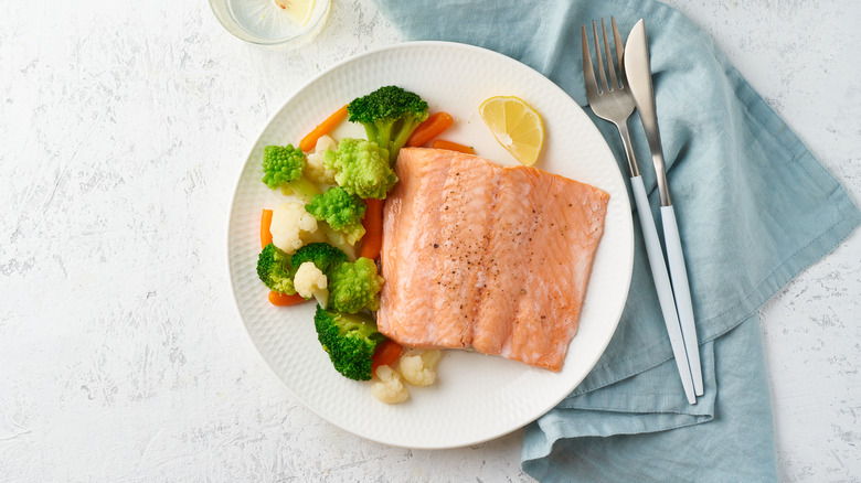 Salmon and veggies on a white plate