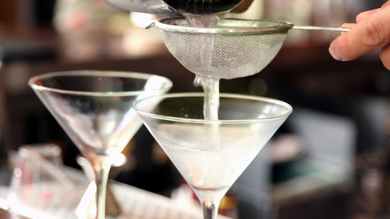 bartender straining a martini