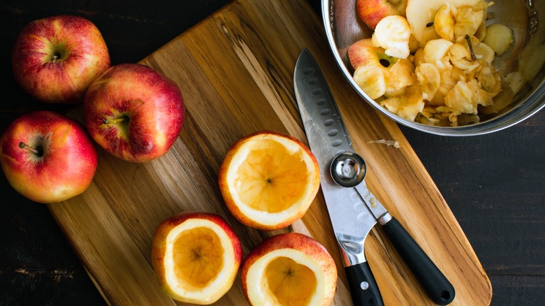 apples on cutting board scraps in bowl