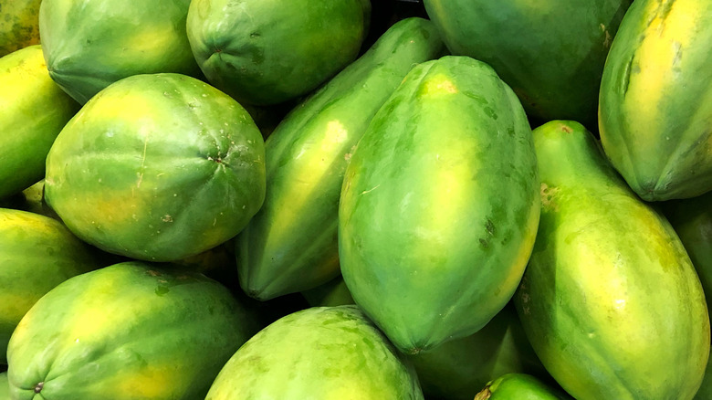 Green papayas in a pile