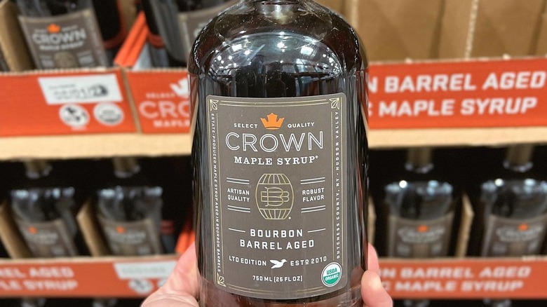 Bottle of Crown Maple Syrup before storage crates