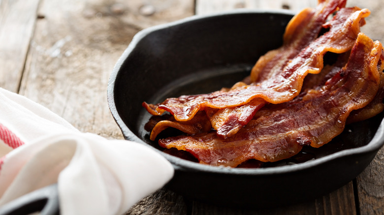 Pieces of bacon in a cast iron skillet 