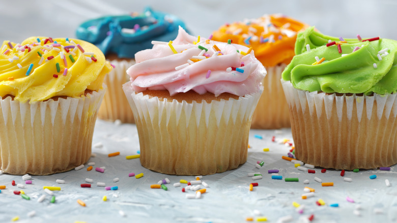 cupcakes decorated with different colored frosting