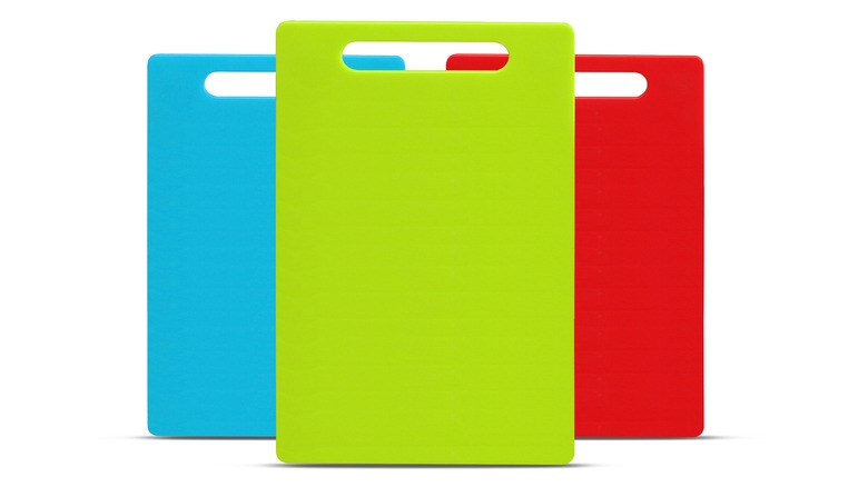 Colorful plastic cutting boards on a white backdrop