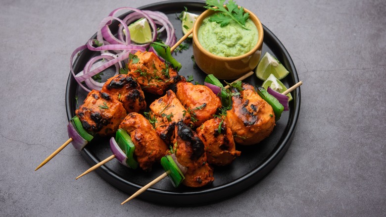 Chicken kebabs with green dipping sauce