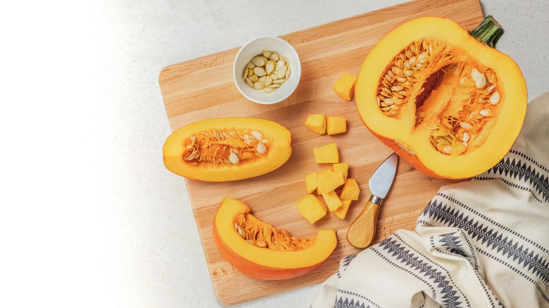A pumpkin open on a cutting board