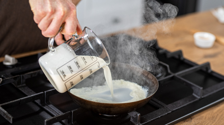 Pouring milk into a pan