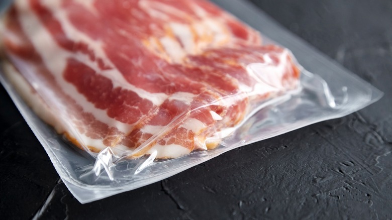 raw bacon in plastic packaging