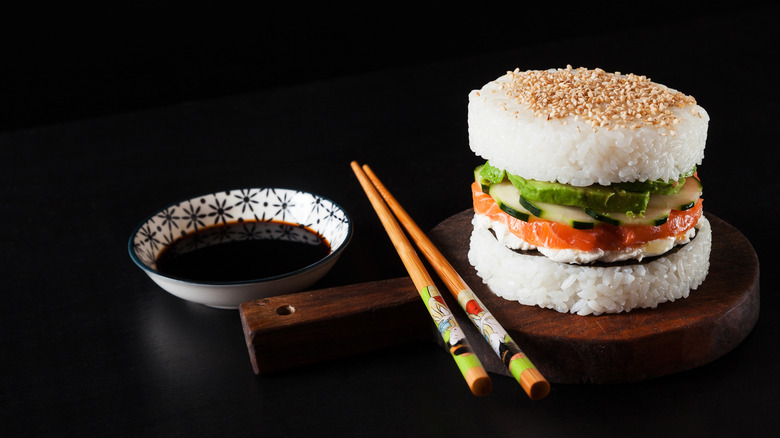 Sushi salmon burger with chopsticks