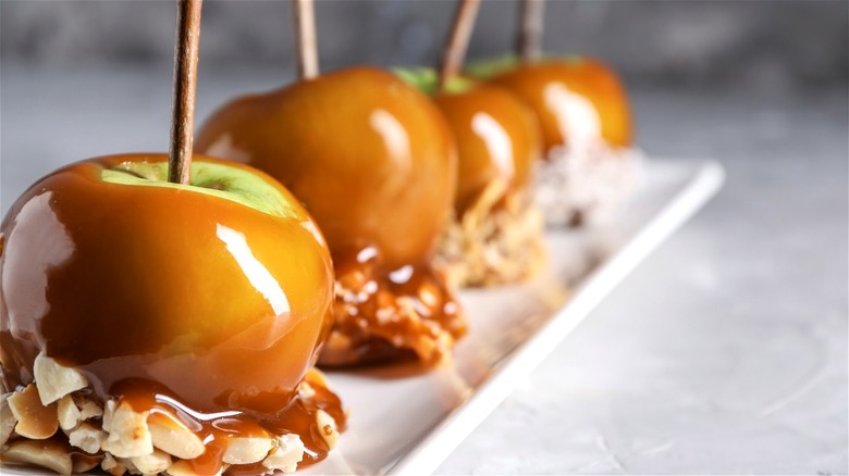 Caramel apples with nuts on sticks