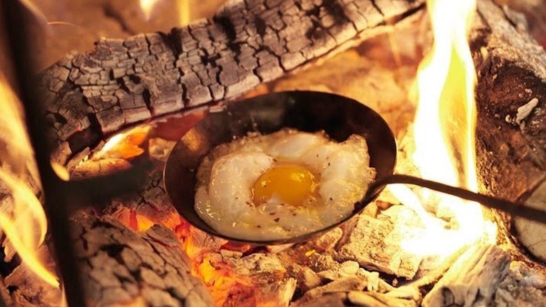 Alice Waters egg spoon over fire