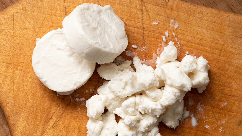 Fresh goat cheese round cut into pieces and crumbled