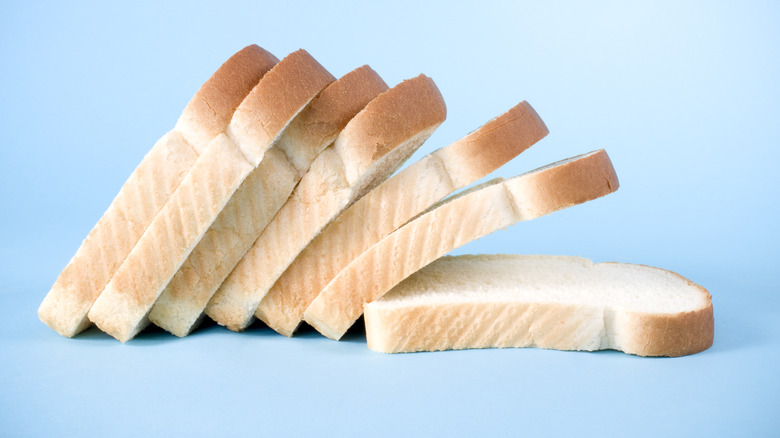 sliced white bread on blue background