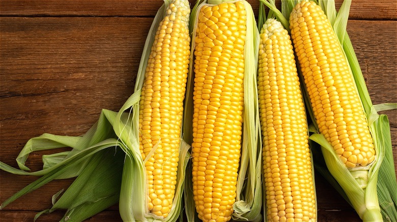 Four raw corn cobs