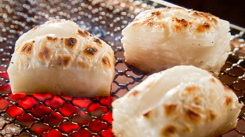 Grilled white mochi on grates