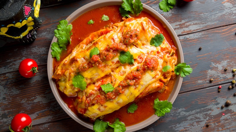 Enchiladas in sauce in bowl