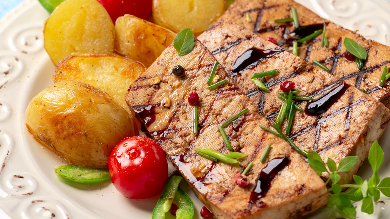 Grilled tofu steaks with potatoes and tomatoes