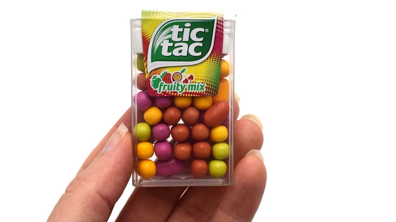 hand holding fruity tic tacs