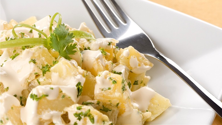 Potato salad with fork on plate 