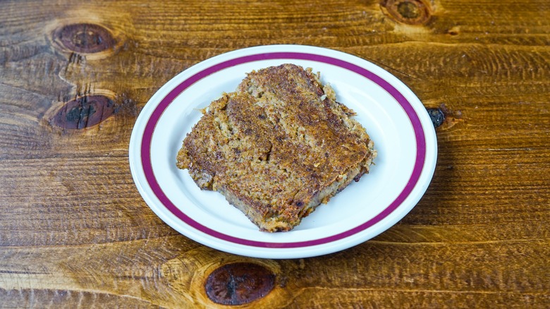 Slice of scrapple on white plate