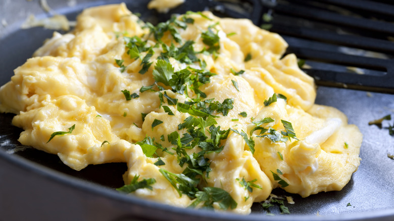 Scrambled eggs served with chopped herbs