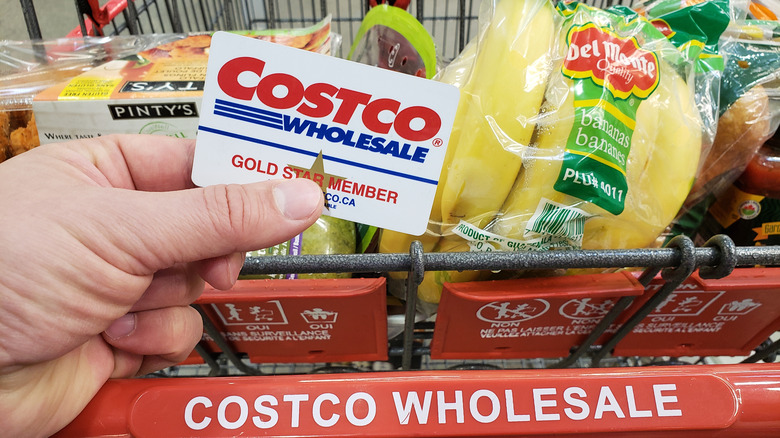 Costco wholesale member card in front of shopping cart