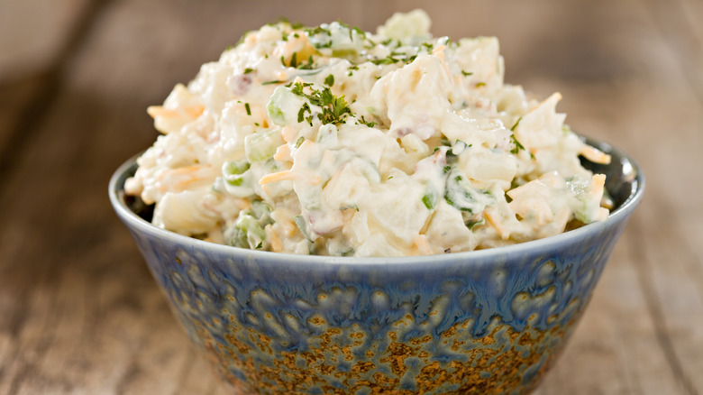 Mayonnaise-based coleslaw in blue stoneware bowl